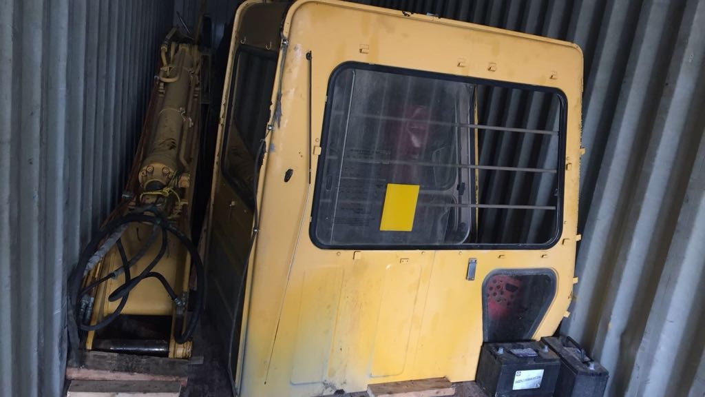 Heavy machinery components loaded inside a container for export